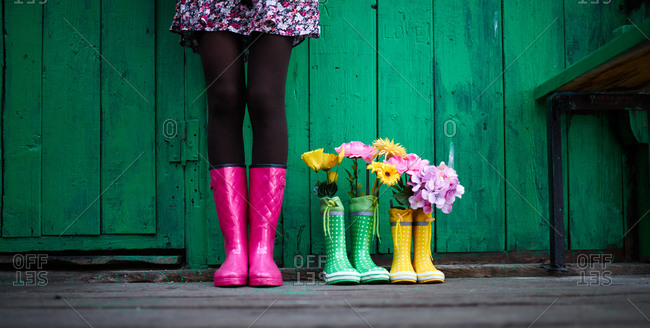 Woman by rain boots with flowers