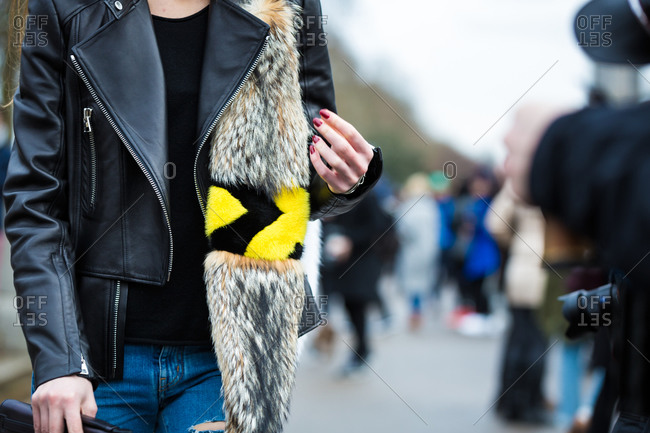 Woman wearing leather jacket with a fur scarf