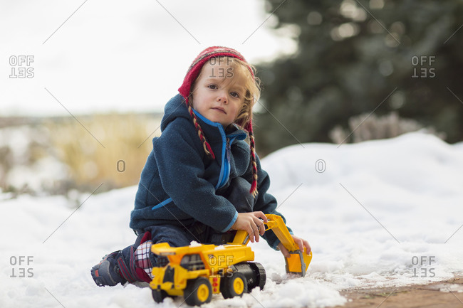 Boy playing with truck in snow