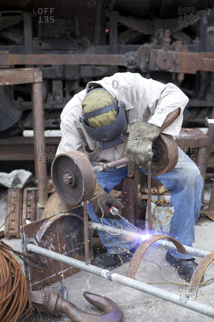 Man welding metal pieces together Havana,\
Cuba