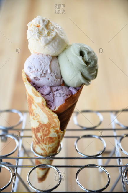 ice cream cone with four scoops in a wire rack