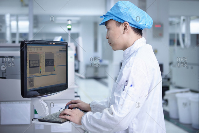 Worker using computer in a factory