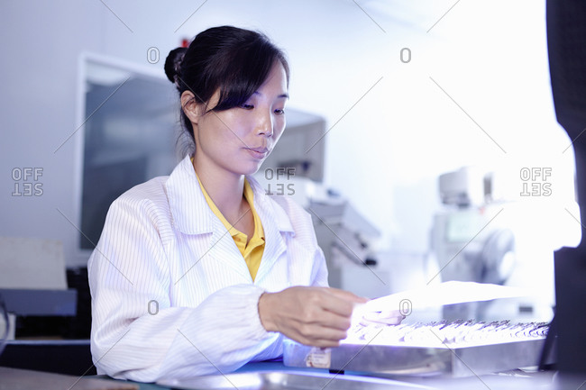 Worker testing products in LED factory