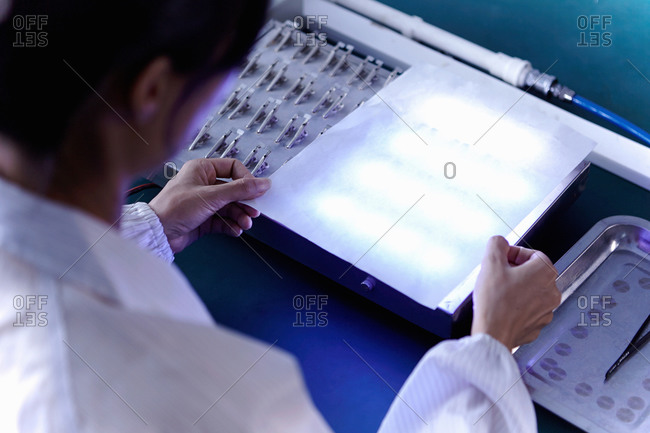 Technician testing products in LED factory