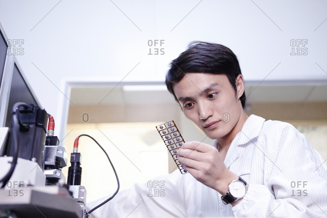 Technician examining products in LED factory