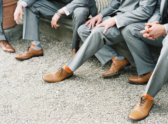Groomsmen with orange socks and brown shoes