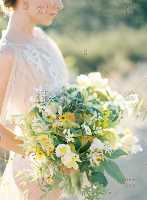 Bride holding bouquet with wildflowers