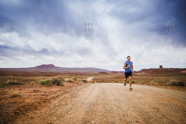 Caucasian man running in desert landscape