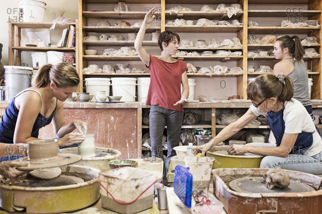 Students and teacher working in ceramic studio