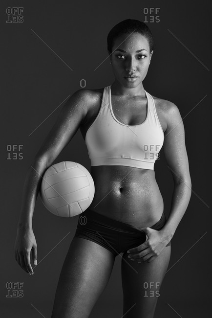 African American woman holding volleyball