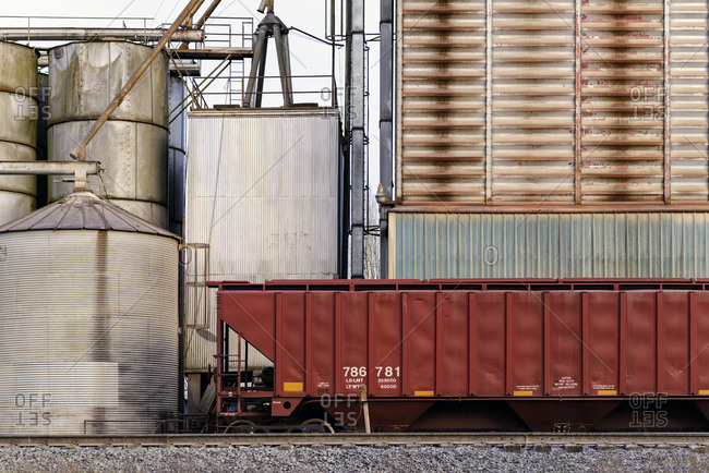 Container on train tracks in industrial train yard