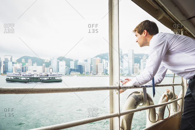 Caucasian businessman admiring view on ferry