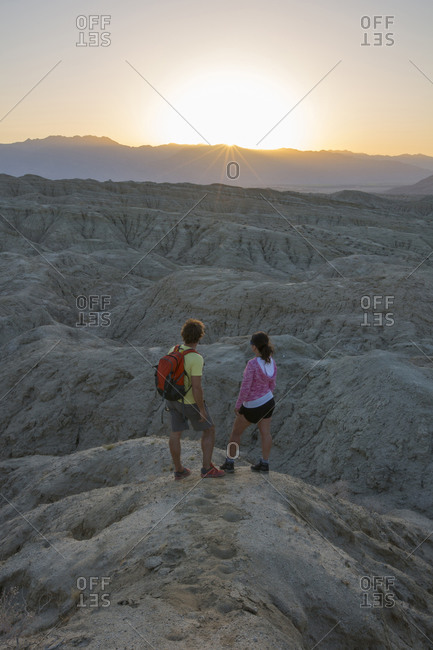 Couple  taking in the view of sunset in the Badlands in the Anza-Borrego Desert, California