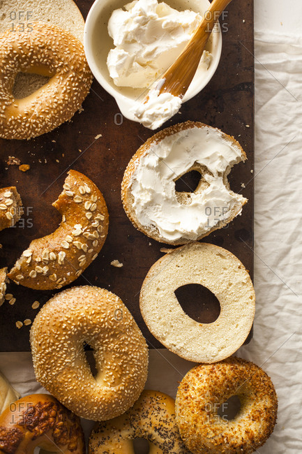 Bagel with cream cheese missing a bite