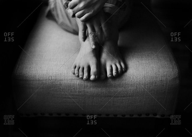 Feet of child on a stool