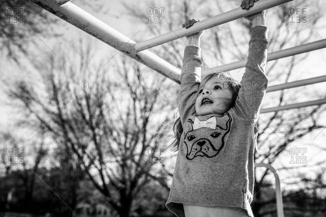Little girl playing at jungle gym