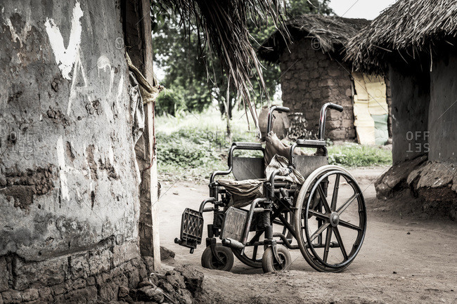 Wheelchair outside a house; Uganda