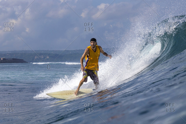 Man in yellow shirt surfing
