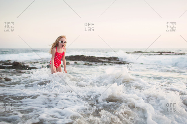 Girl surprised by ocean waves