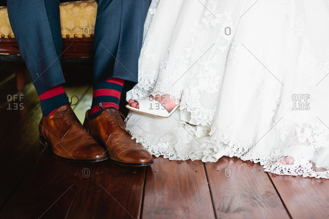 Feet of sitting bridal couple