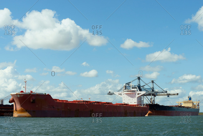 Huge ships moored in the Rotterdam harbor, used for transporting coal and iron ore