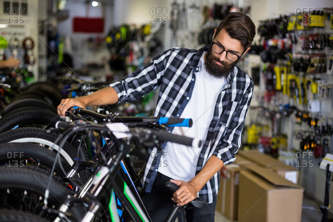 Bike mechanic checking bicycles in bike repair shop