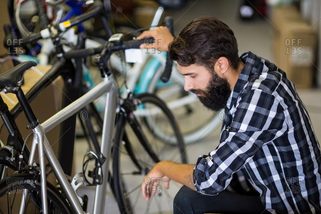 Bike mechanic checking on a bicycle in bike repair shop