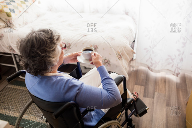 Senior woman drinking coffee in a retirement home