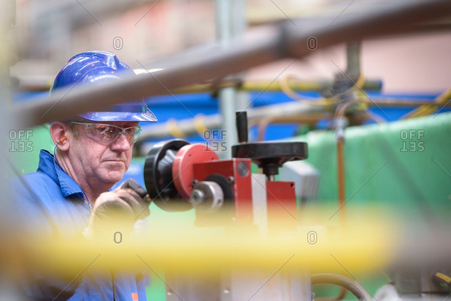 Engineer operating boring machine during power station outage