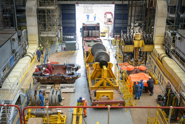 Turbine on truck in turbine hall during power station outage, high angle view