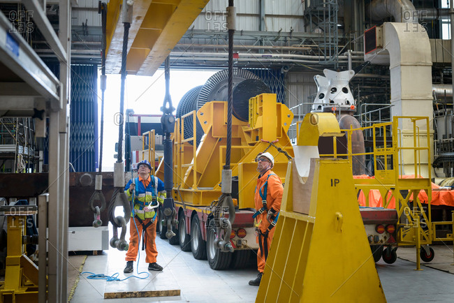 Banksman and crane operator working together to lower a crane to turbine hall