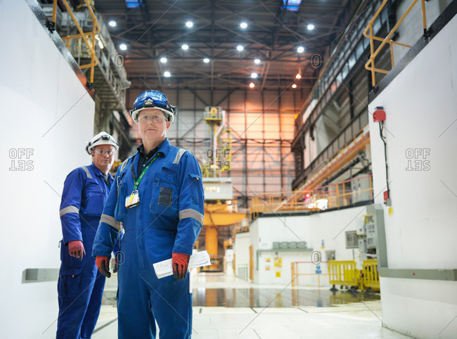 Portrait of two engineers in reactor hall in nuclear power station