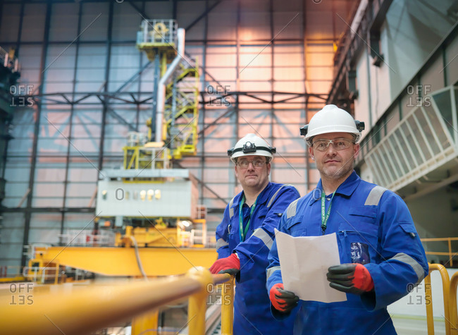 Portrait of engineers in reactor hall in nuclear power station