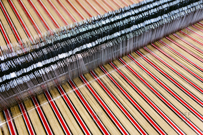 Close up of striped textile on weaving machine in woolen mill