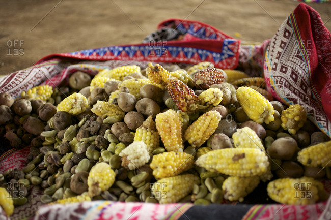 Peruvian feast of corn, potatoes and beans on blanket