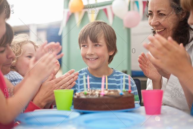 Mother and group of children enjoying birthday party