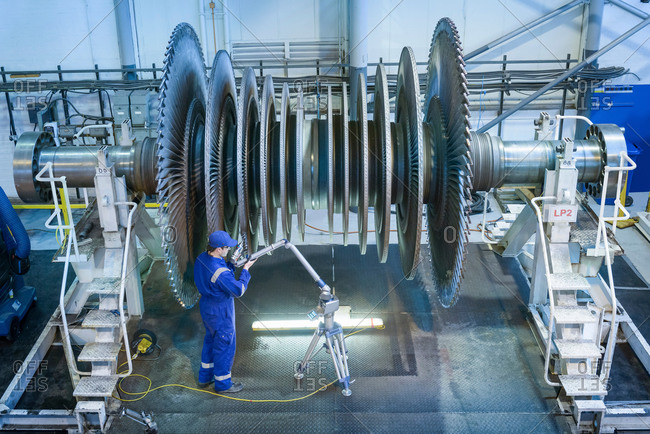 Engineer measuring low pressure steam turbine parts in repair works