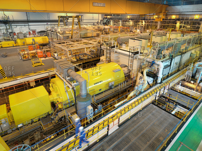 High angle view of workers in turbine hall of power station