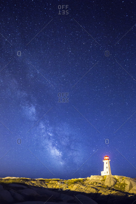 Peggy\'s Cove Lighthouse at night with the Milky Way in the night sky