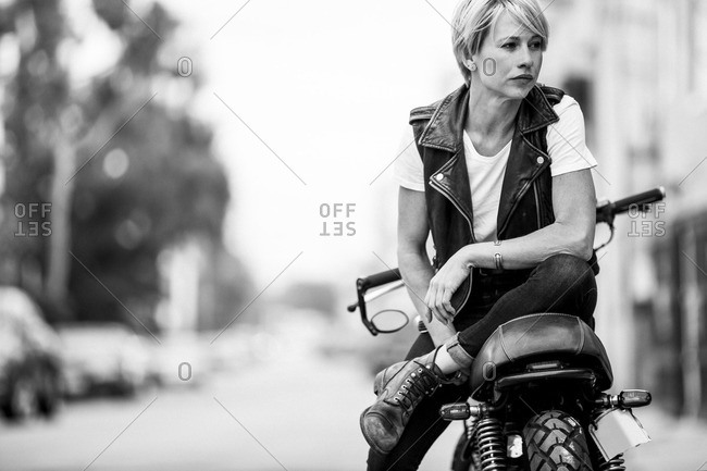 Woman sitting on a motorcycle on the street