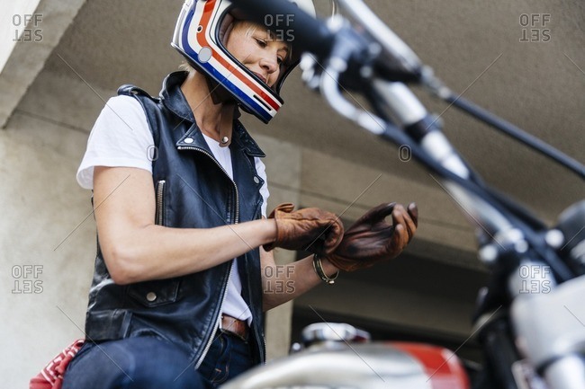 Woman preparing to ride a motorcycle