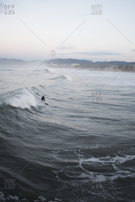 Surfer riding waves off of Venice Beach