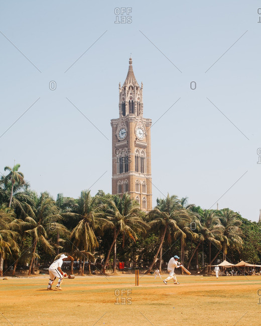 Cricket match near a clock tower