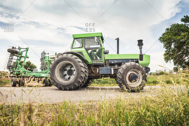 Farmer driving tractor on rural road