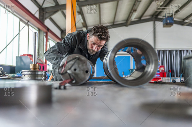 Man in front of hydraulic cylinder