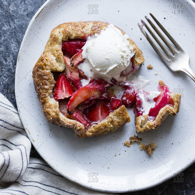 Strawberry rhubarb galettes with a bite out of it