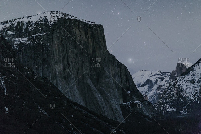 Starry sky over snowy mountains