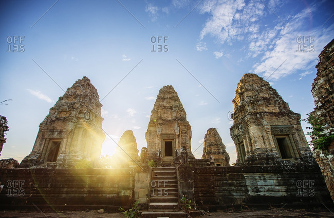 Low angle view of Angkor Wat temple against sky during sunset