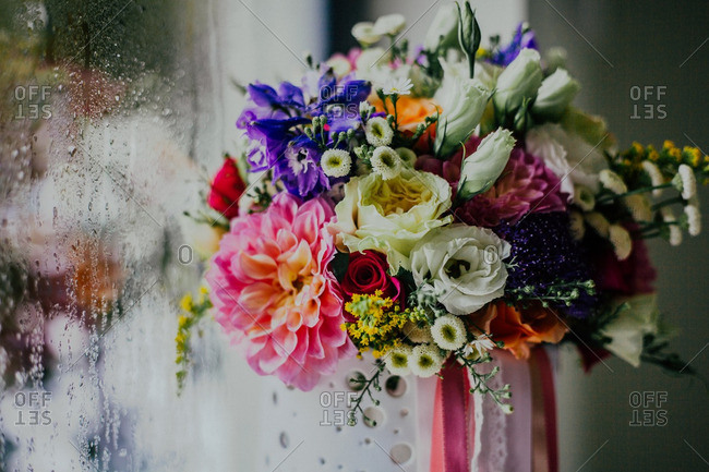 Bouquet of flowers against a window covered in condensation