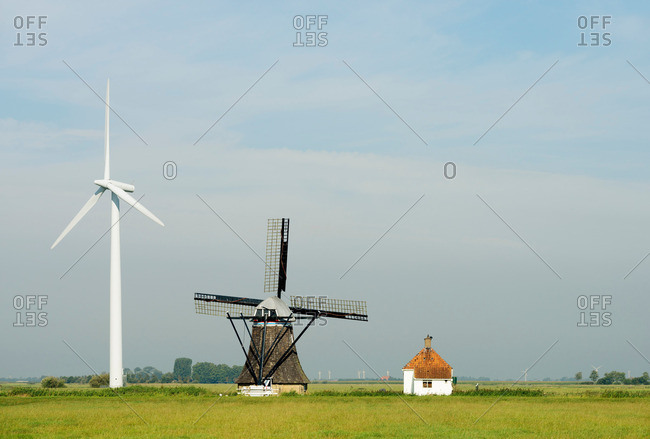 Wind turbine and windmill, Tjerkwerd, Friesland, Netherlands
